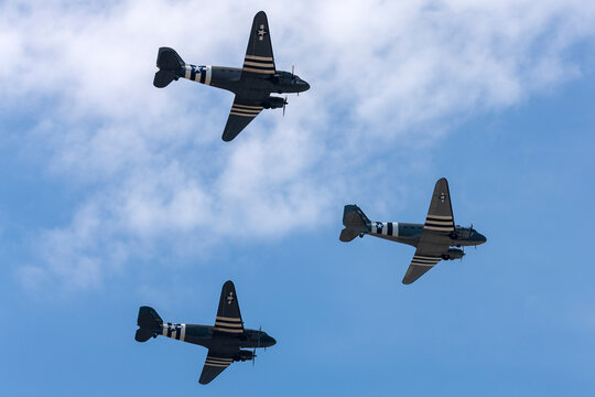 Farnborough, UK - July 20, 2014:   .Three World War II era Douglas C-47 (DC-3) transport aircraft with D-day invasion stripes flying in formation..