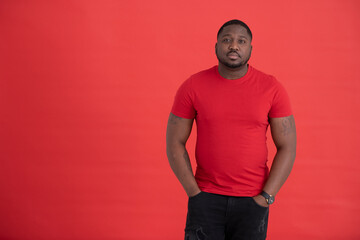 Fototapeta premium Studio portrait of mid adult wearing red t-shirt