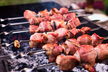 Appetizing juicy shish kebab on skewers fried on grill