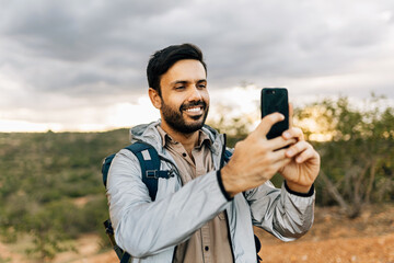Man hiking and taking pictures with smartphone in Brazilian Caatinga