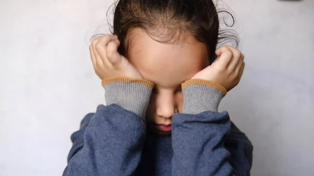 a upset child girl looking down 