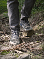 Feet walk a hard rocky path