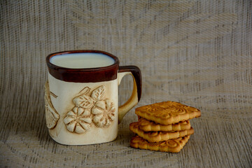 A cup of milk and a lot of cookies on a beautiful background. Breakfast.