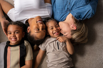 Mothers and sons cuddling on floor © Cultura Creative