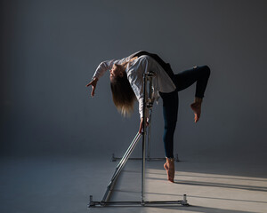 Caucasian woman posing at the ballet barre. 