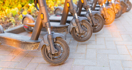 Electric scooters parked on city street. Self-service street transport rental service. Rent urban...