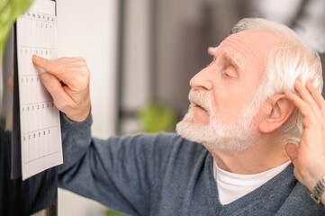 Senior male patient undergoing a post-stroke rehabilitation