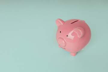 Piggy bank isolated on a blue background with copy space. Savings, investment and finance concept