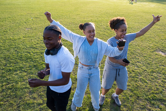 Friends Dancing In Park