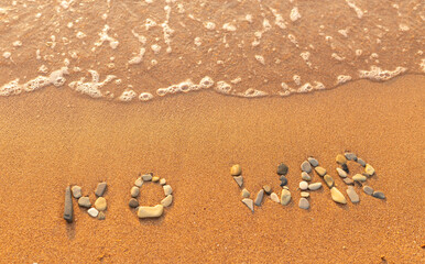Words written in the sand on the beach. The words No War and written in the Sand with the Ocean in the background. Protest War sign written in sand. World Peace. No War