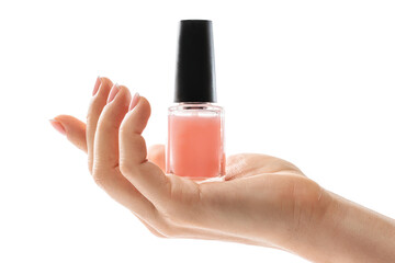 Female hand with beautiful french manicure holding bottle of pink nail polish against white background