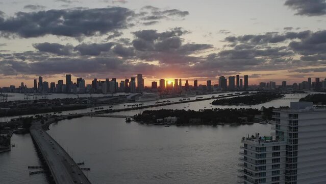 beautiful descending images of the orange sky and sun behind the skyscrapers of miami in the us