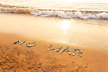Words written in the sand on the beach. The words No War and written in the Sand with the Ocean in the background. Protest War sign written in sand. World Peace. No War