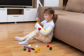 River fracture in a child. A little girl paints on plaster, bandages