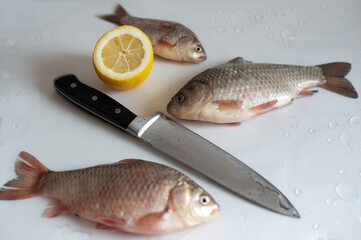 Live crucians. Knife. Scales. Bloody crucian. Three crucians. Delicious food. Delicious. After fishing. The catch.
