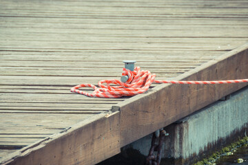 Colorful rope on bridge as part of yacht anchor. Detail of sailboat