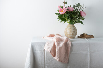 Elegant pink linen runner on the white tablecloth