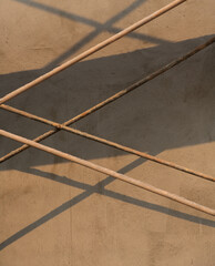 lines of rusty metal piping of scaffolding criss crossing each other creating lines and angles and...
