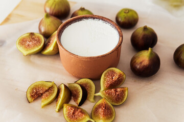 Delicious natural Greek yogurt in clay bowl with figs