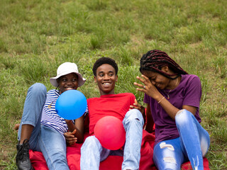 Group of young friends relaxing on grass