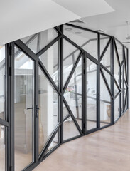 glass partition in a white office, window with black frame