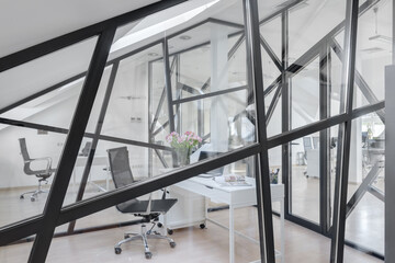 glass partition in a white office, window with black frame
