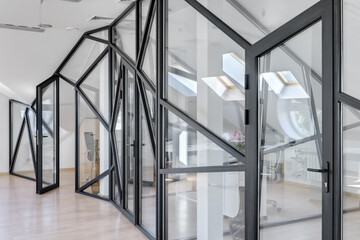 glass partition in a white office, window with black frame