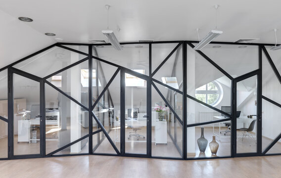 glass partition in a white office, window with black frame