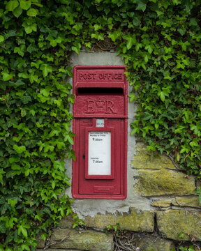Rather than putting a full pillar box in a small village the post office will often insert a small mail box into a wall with limited rural collection times