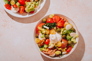 Fresh mediterranean salad with tomatoes and burrata cheese, top view