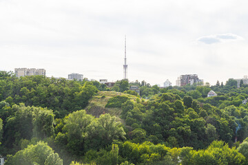 Obraz premium Kyiv, Ukraine – July 08, 2017: A beautiful panorama of Podil area. Aerial view on residential and industrial areas. A lot of buildings of different architectural style. Historical area, Dnipro river.