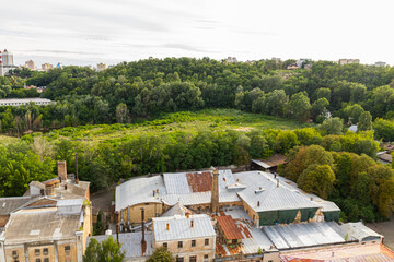 Fototapeta premium Kyiv, Ukraine – July 08, 2017: A beautiful panorama of Podil area. Aerial view on residential and industrial areas. A lot of buildings of different architectural style. Historical area, Dnipro river.