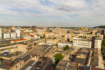 Obraz premium Kyiv, Ukraine – July 08, 2017: A beautiful panorama of Podil area. Aerial view on residential and industrial areas. A lot of buildings of different architectural style. Historical area, Dnipro river.