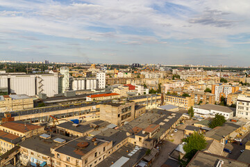Fototapeta na wymiar Kyiv, Ukraine – July 08, 2017: A beautiful panorama of Podil area. Aerial view on residential and industrial areas. A lot of buildings of different architectural style. Historical area, Dnipro river.