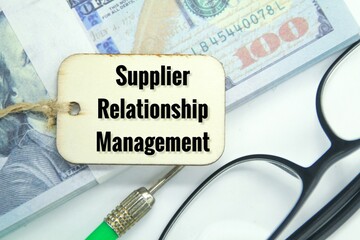 glasses, banknotes and wooden tags with the words supplier relationship management