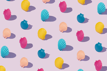 Pattern with multicolored shells on a purple background. Creative summer abstract concept....