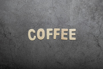 Coffee text word written on wooden letters on a grey textured board
