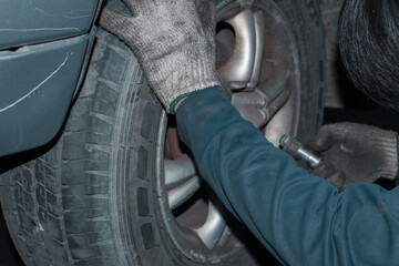 The mechanic is checking the engine.