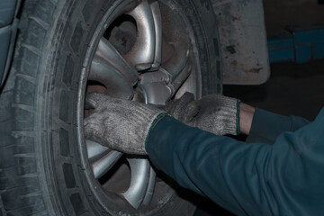 The mechanic is checking the engine.