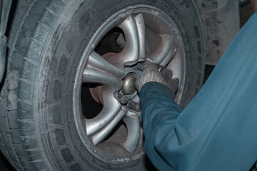 The mechanic is checking the engine.