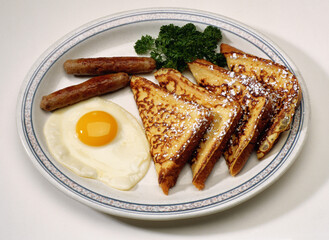 Scruble egg, toasts and sausages on breakfast
