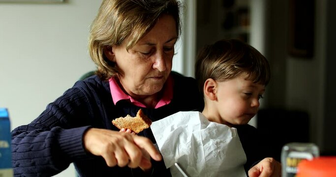 Child refusing food kid not wanting to eat sitting on grandmother lap