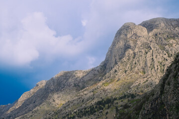 summer mountain peak landscape with sky and clouds, powerful nature, green forest in mountains, summer travel hiking background