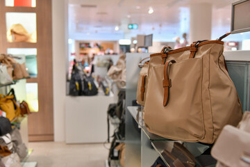 Leather women's bags on the counter of a store in a mall.