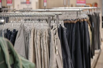 Women's trousers are hanging on a hanger for sale in the mall.
