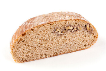 A cut half of a round healthy bread made of whole wheat flour on sourdough close-up on a white isolated background. Proper nutrition.