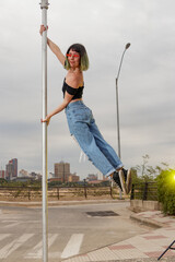 Woman practicing Poledance on square poles