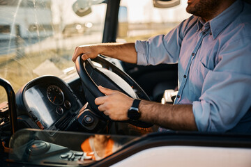 Close up of truck driver driving on the road.