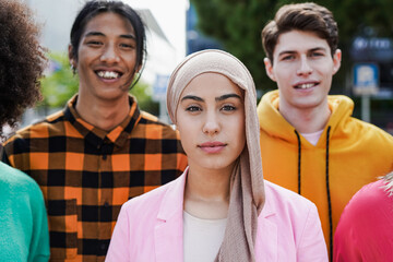 Young diverse people lookign on camera in the city