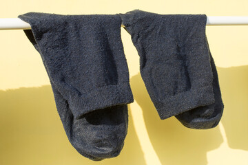 Washed men's socks are dried in the sun.